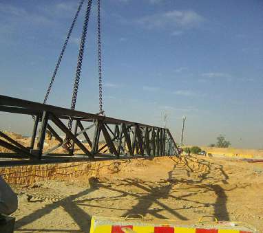 Crane and long steel members positioned for installation